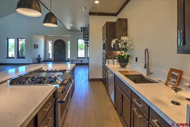 a kitchen with stainless steel appliances a stove a sink and a refrigerator