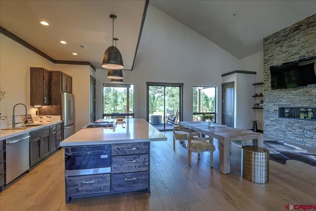 a large kitchen with lots of counter space a sink appliances and cabinets