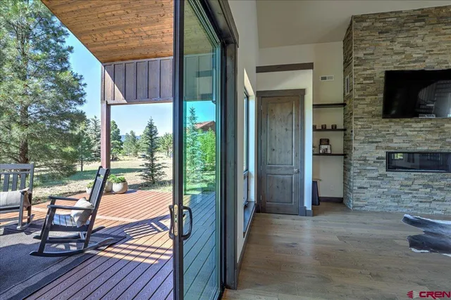 a view of a balcony with chair and wooden floor