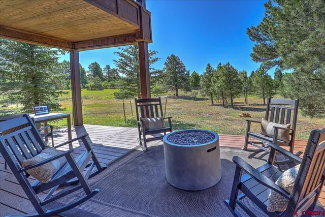 a view of a patio with a table chairs and a backyard