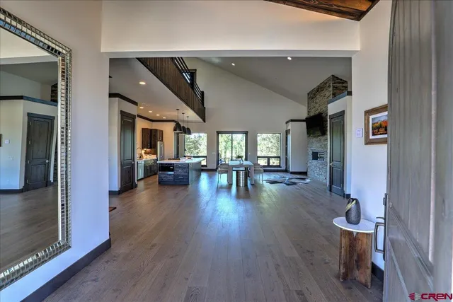 a livingroom with furniture wooden floor and a fireplace