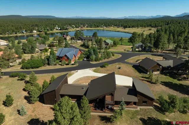 an aerial view of a house with a lake view