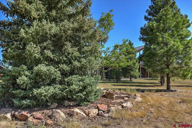 a view of a house with a large window and wooden fence