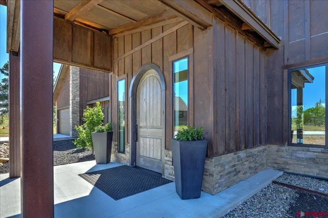 a view of a house with potted plants