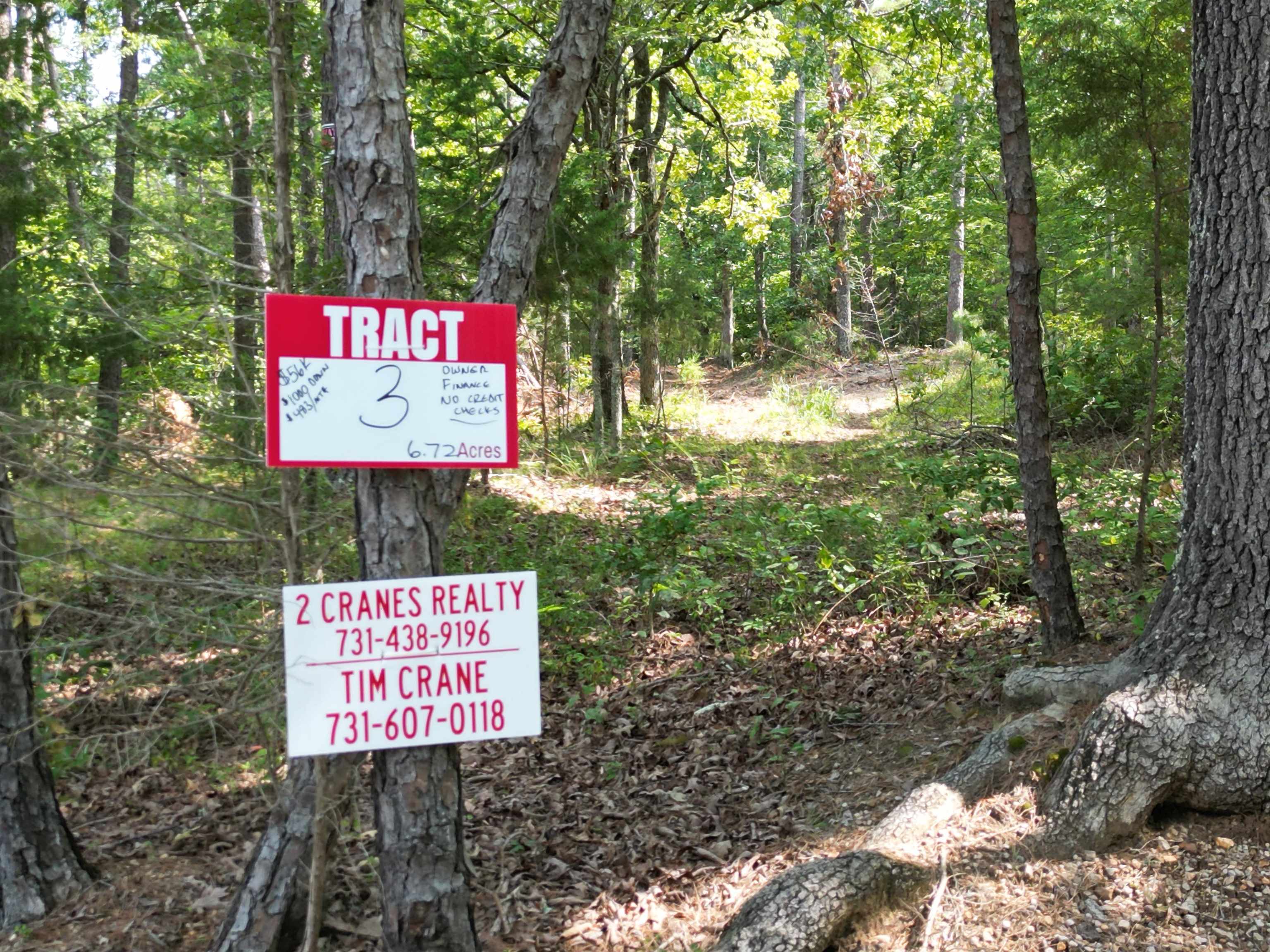 3 Talley Road Hornsby, TN 38044 - Photo 2 of 16 a sign that is sitting in the forest