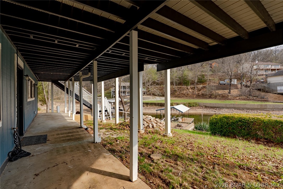 131 Frudeger Road Lake Ozark, MO 65049 - Photo 51 of 78 Steps down from upper deck to patio and walk way t