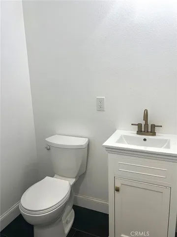 a white toilet sitting next to a bathroom sink