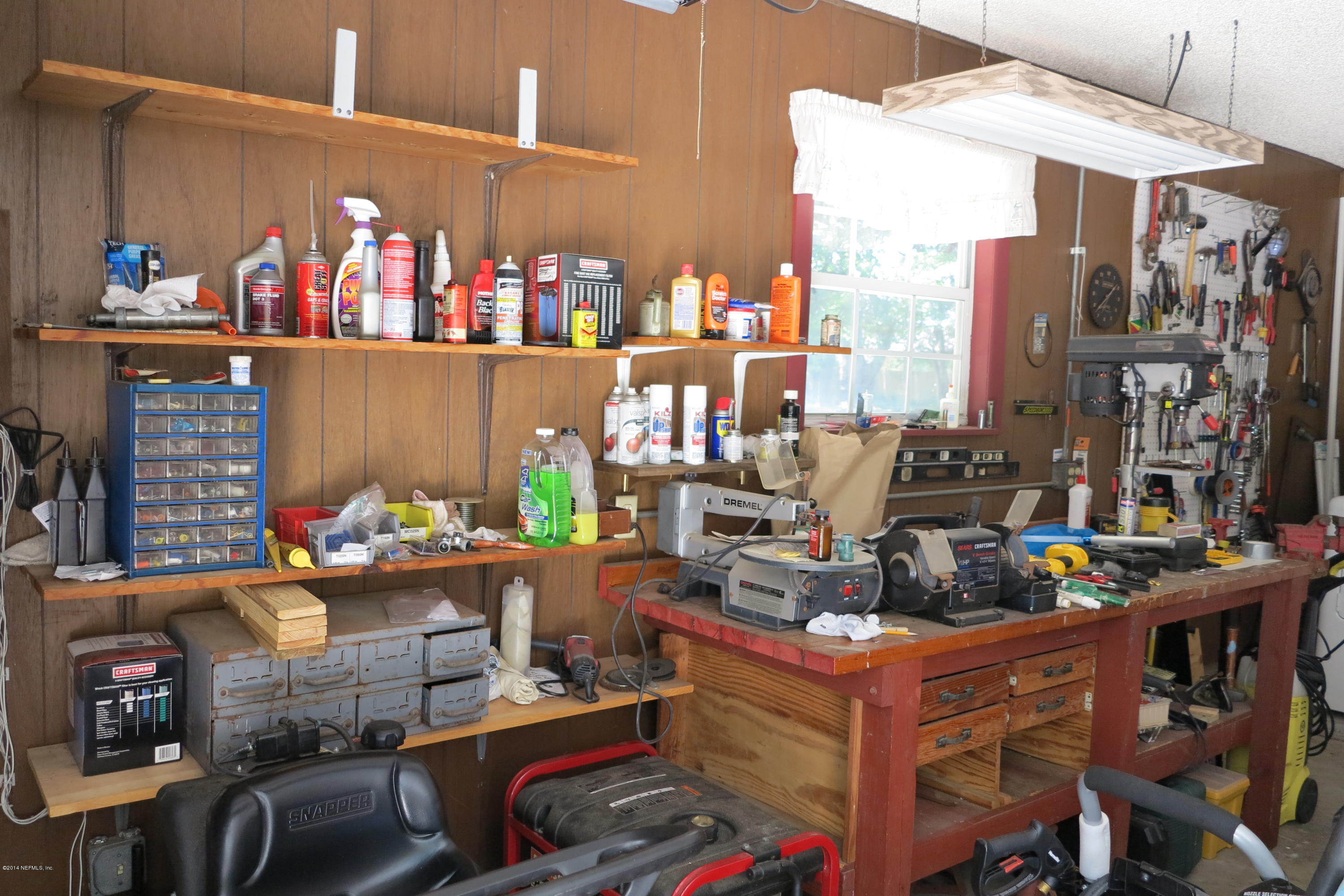 2095 Orange Picker Road Jacksonville, FL 32223 - Photo 63 of 67 Garage workbench and shelving