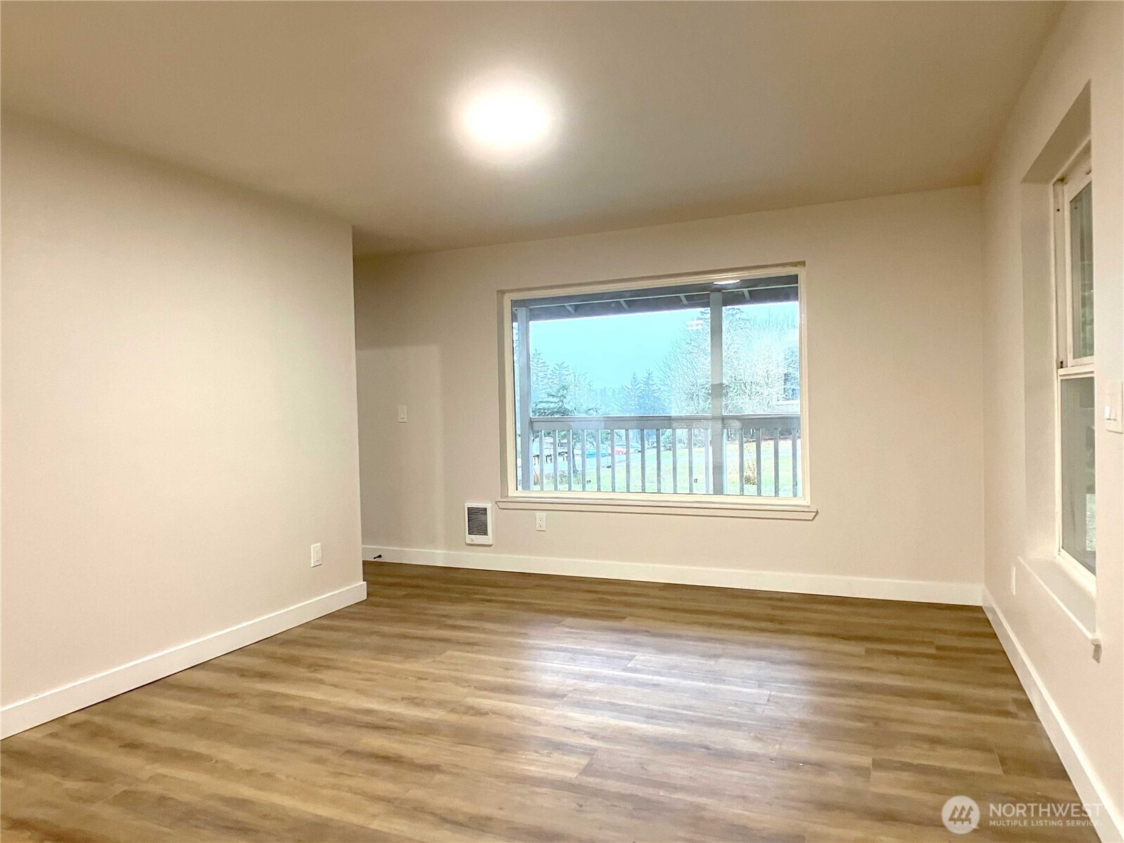 1471 Southeast Binns Swiger Loop Road Shelton, WA 98584 - Photo 11 of 25 a view of an empty room with wooden floor and a window