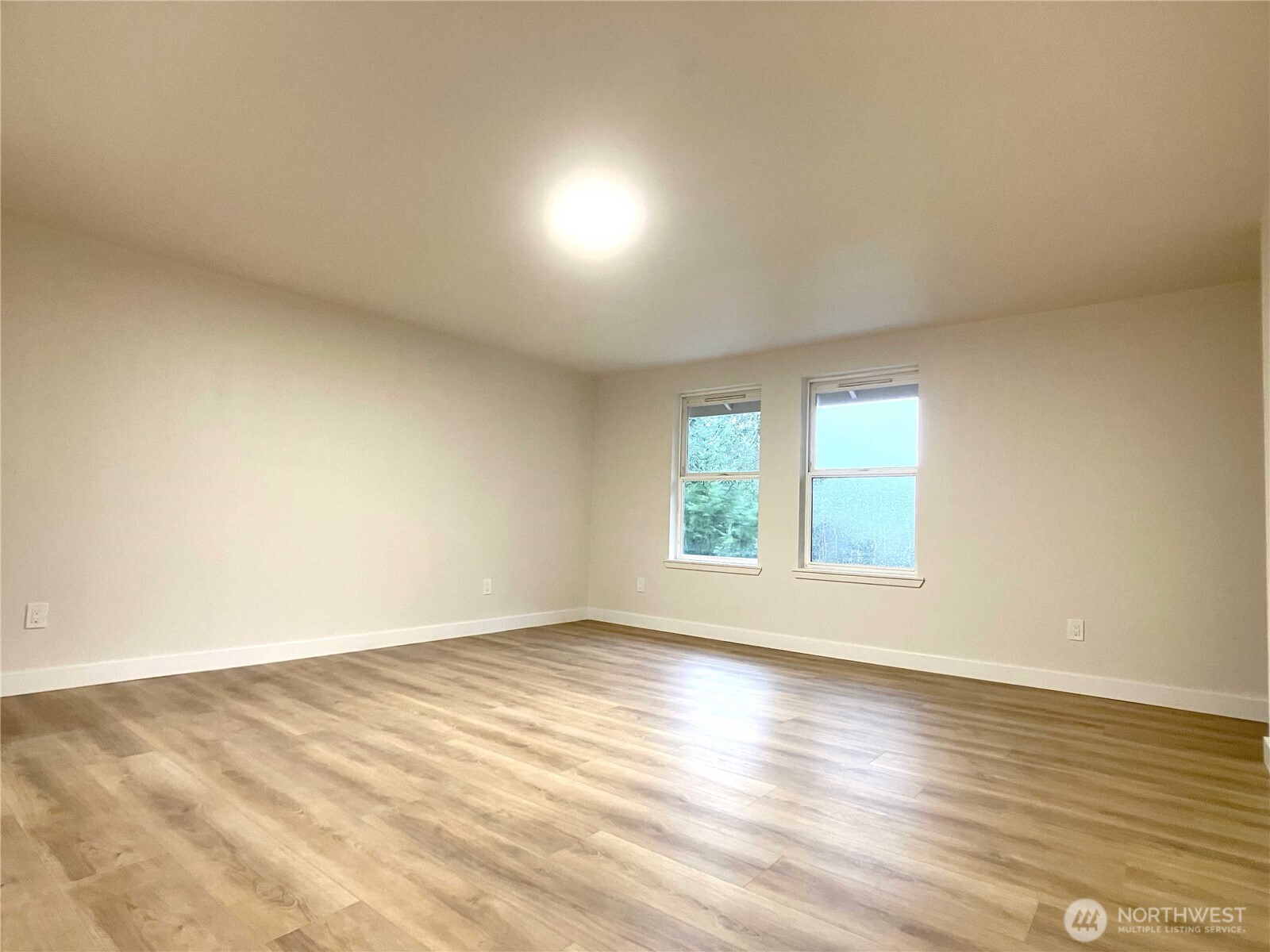 1471 Southeast Binns Swiger Loop Road Shelton, WA 98584 - Photo 13 of 25 an empty room with wooden floor and windows