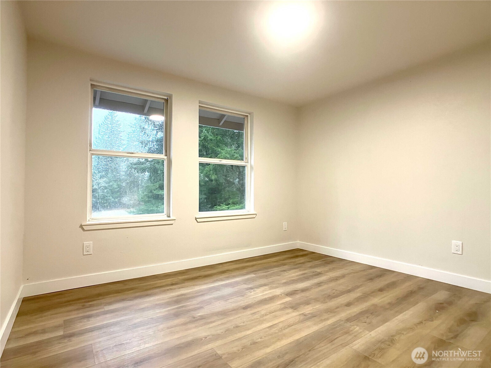 1471 Southeast Binns Swiger Loop Road Shelton, WA 98584 - Photo 18 of 25 an empty room with wooden floor and windows