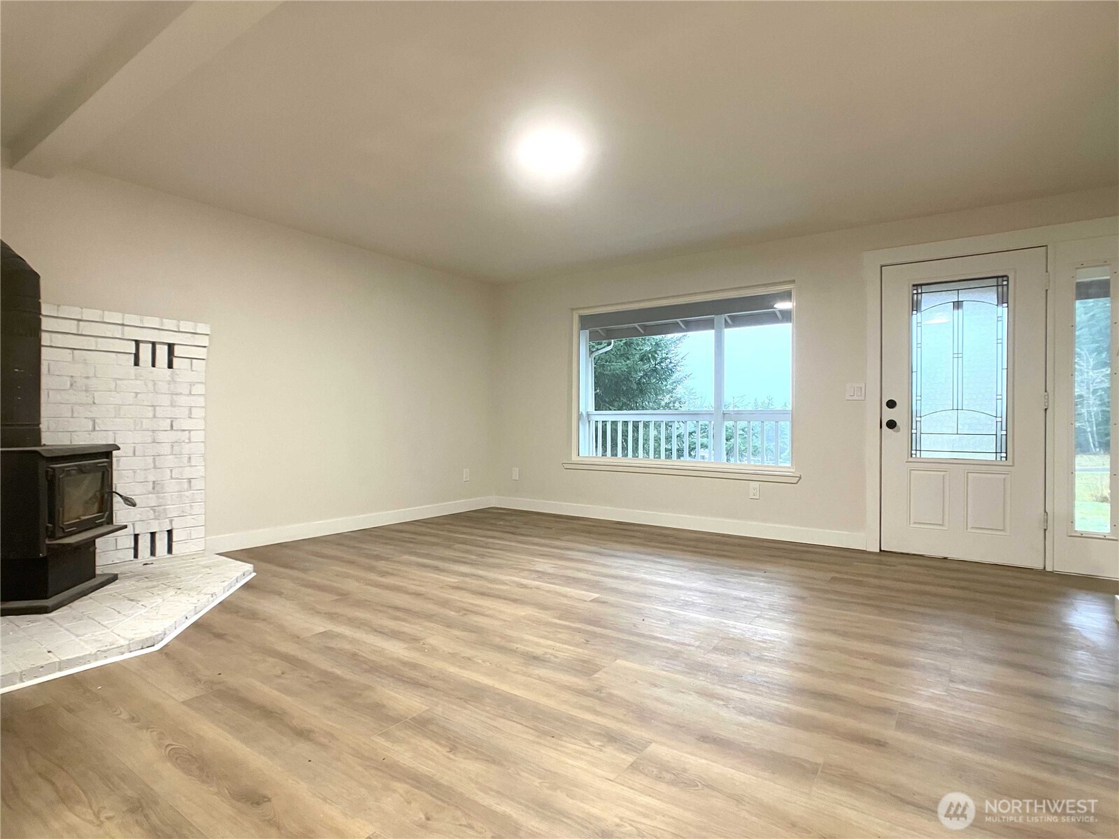 1471 Southeast Binns Swiger Loop Road Shelton, WA 98584 - Photo 5 of 25 an empty room with wooden floor and windows