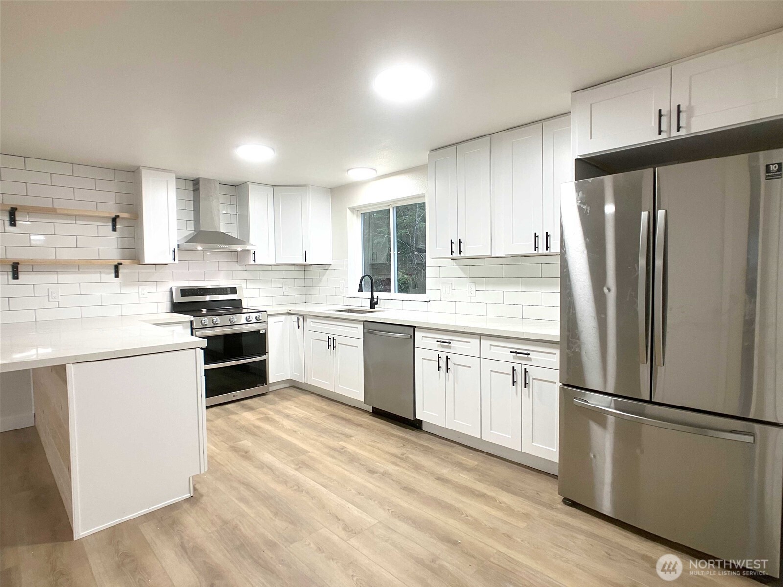 1471 Southeast Binns Swiger Loop Road Shelton, WA 98584 - Photo 7 of 25 a kitchen with a refrigerator stove top oven and cabinets