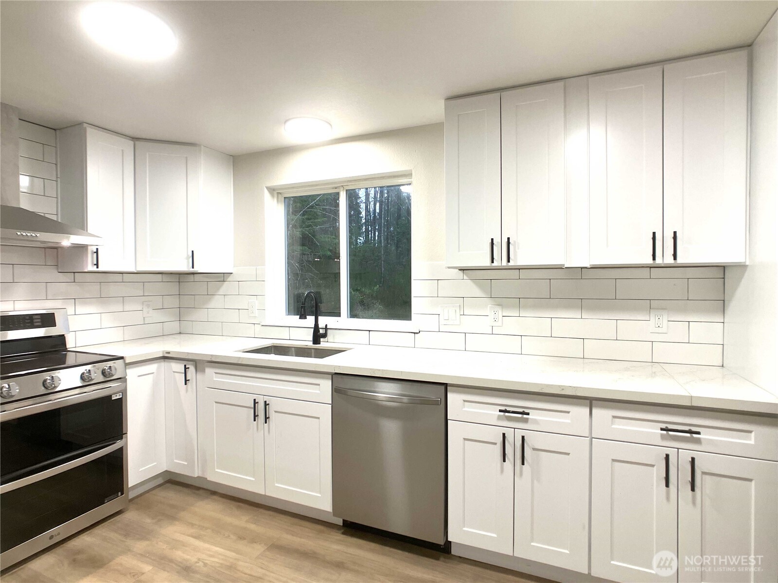 1471 Southeast Binns Swiger Loop Road Shelton, WA 98584 - Photo 9 of 25 a kitchen with white cabinets sink and appliances