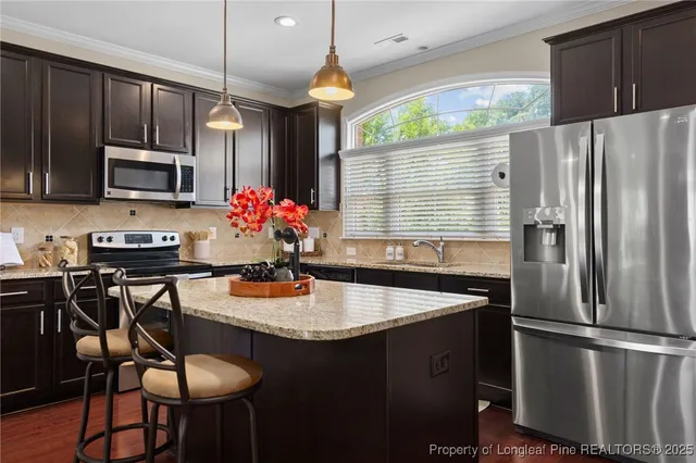 a kitchen with wooden cabinets and a sink