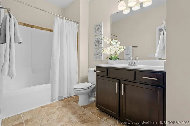 a bedroom with a bed chandelier and window