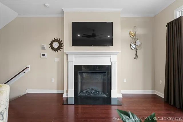 a kitchen with stainless steel appliances kitchen island granite countertop a dining table chairs and a refrigerator