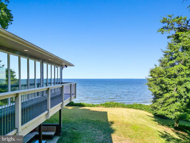 a view of a house with swimming pool and porch