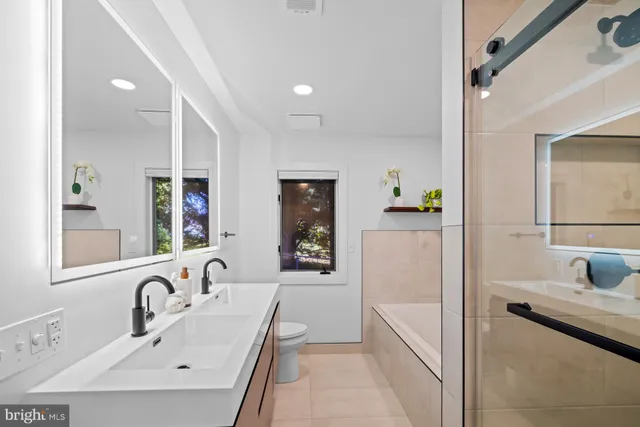 an aerial view of a house with a yard and lake view