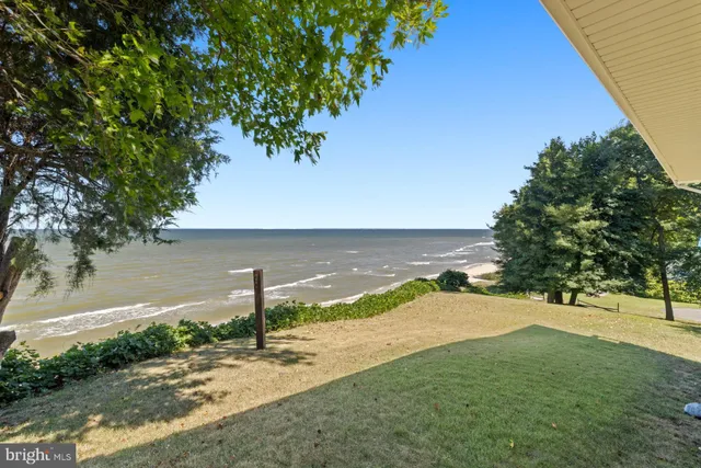 a living room with furniture a wooden floor and a flat screen tv