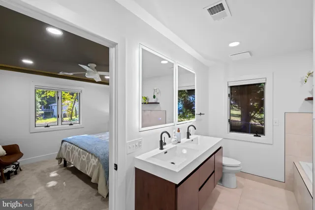 an aerial view of residential house with outdoor space and trees all around