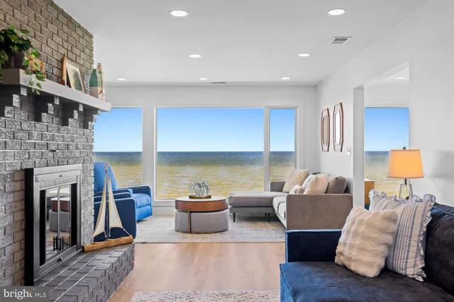 a view of a dining room and livingroom with furniture wooden floor and a rug