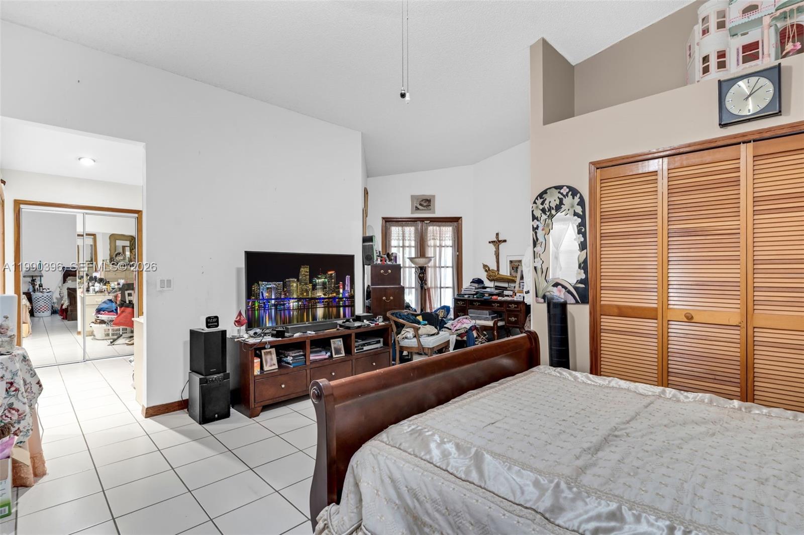 15012 Southwest 45th Lane Miami, FL 33185 - Photo 17 of 43 a bedroom with furniture and a flat screen tv