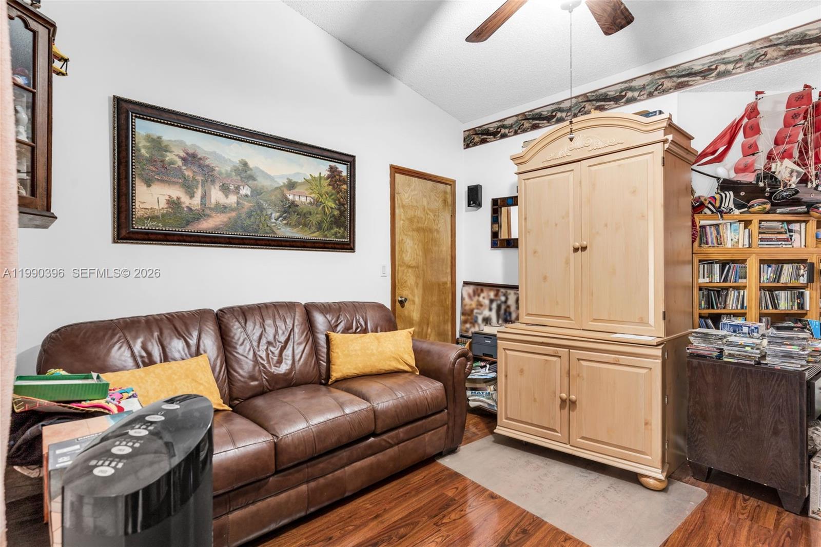 15012 Southwest 45th Lane Miami, FL 33185 - Photo 18 of 43 a living room with furniture and a kitchen view