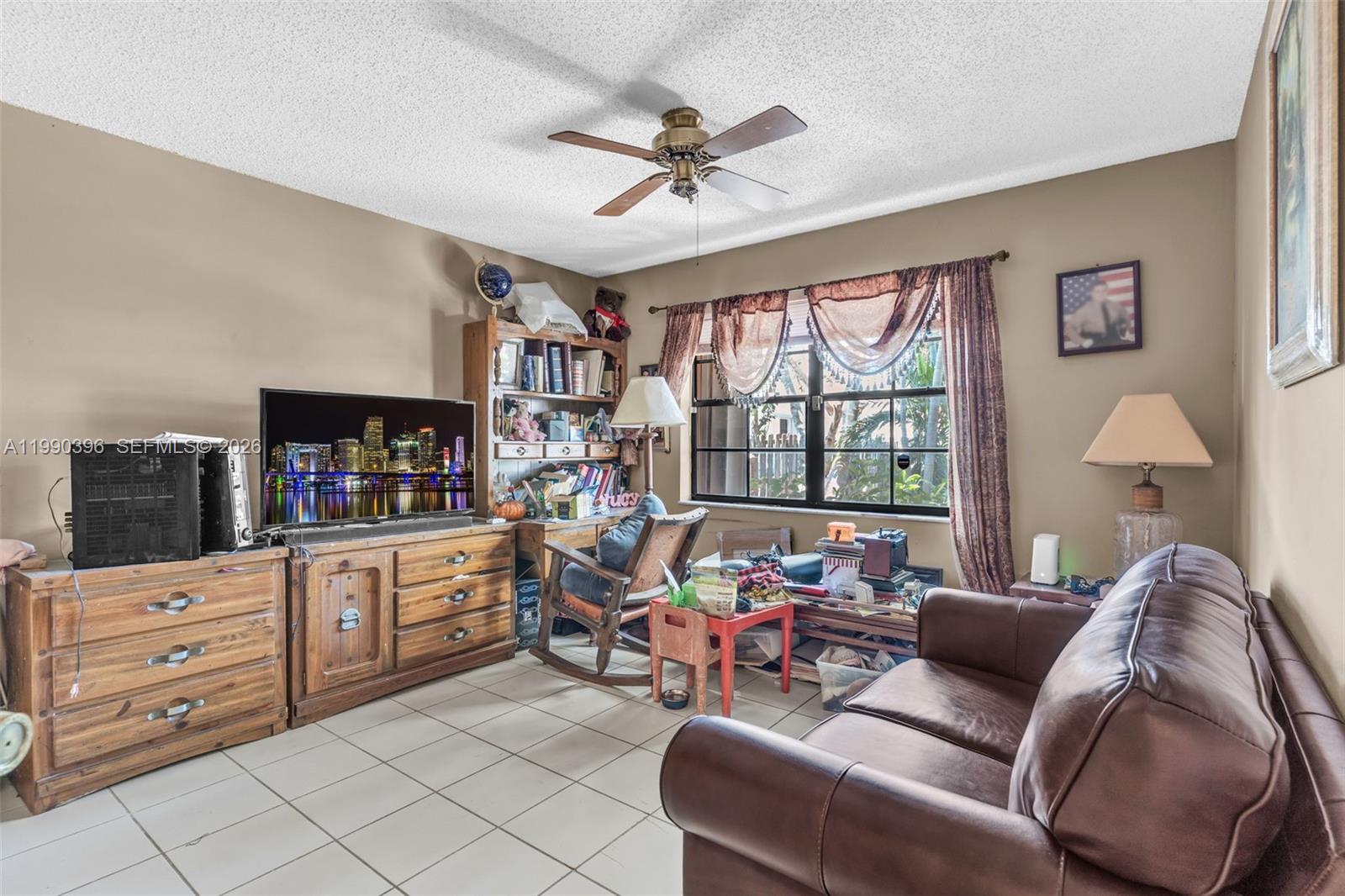 15012 Southwest 45th Lane Miami, FL 33185 - Photo 21 of 43 a living room with furniture and a window