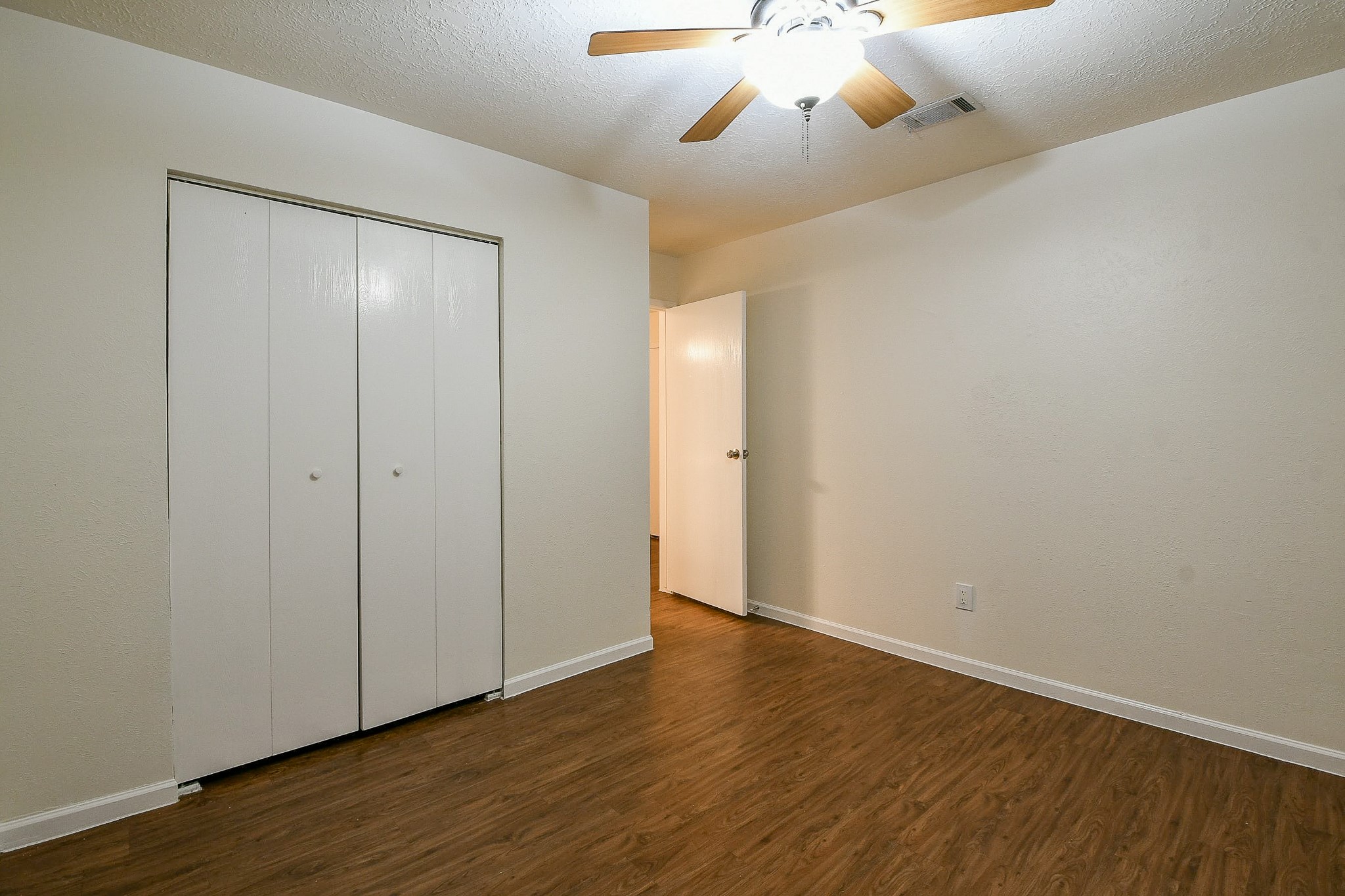 26 Yewleaf Road The Woodlands, TX 77381 - Photo 15 of 21 a view of an empty room with wooden floor