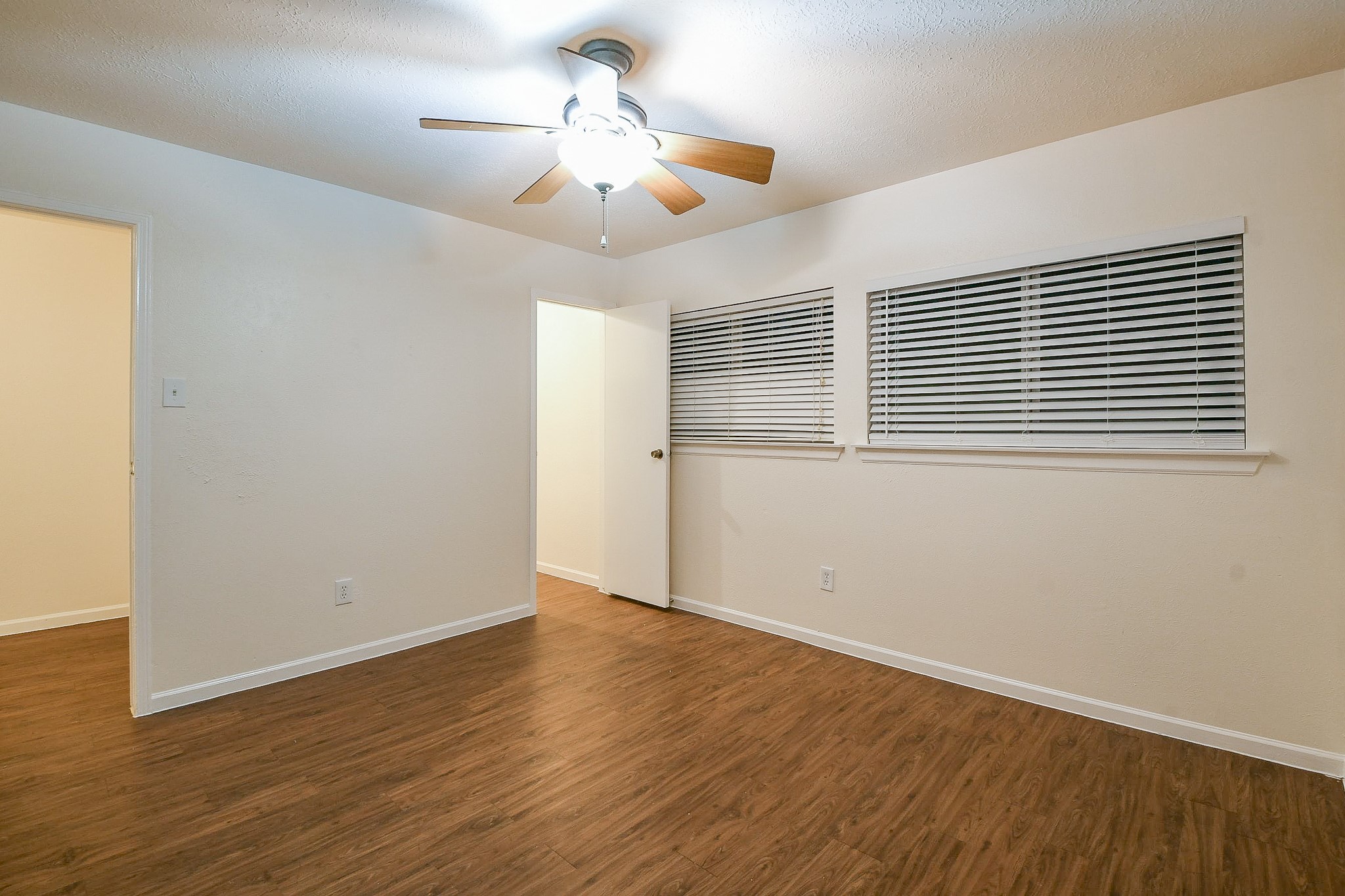 26 Yewleaf Road The Woodlands, TX 77381 - Photo 16 of 21 a view of an empty room with wooden floor and a window