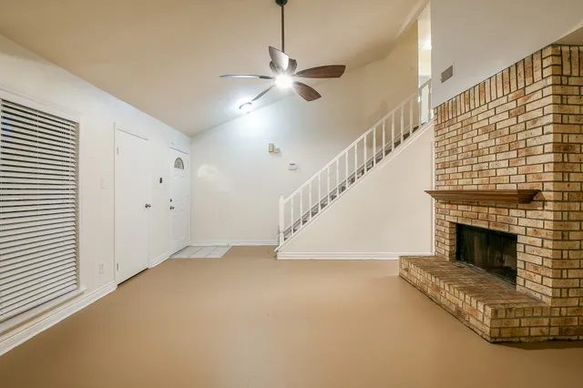 a view of empty room with fireplace