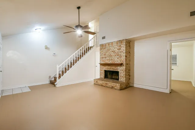 a view of empty room with fireplace