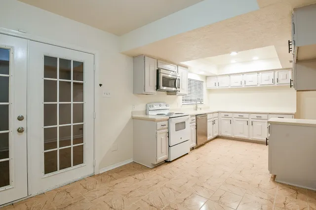 a kitchen with cabinets stove and a sink