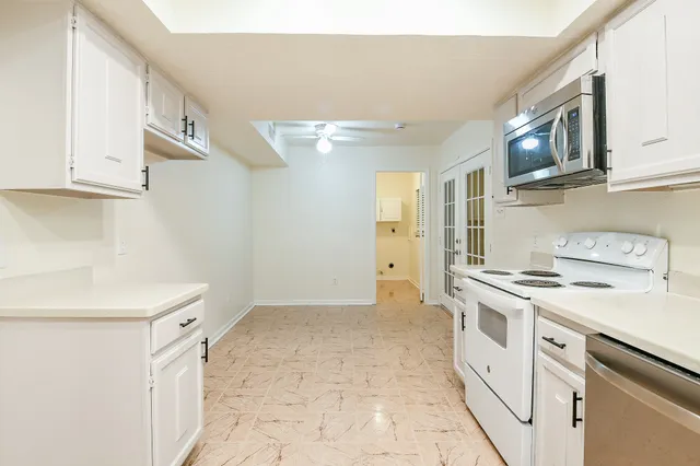 a kitchen with stainless steel appliances granite countertop a stove and a sink