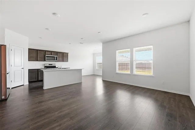 a kitchen with a sink stove top oven and cabinets