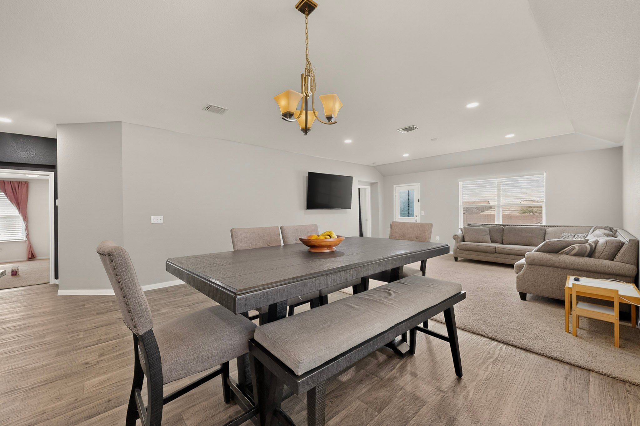 11612 Andesite Road Manor, TX 78653 - Photo 14 of 40 An open-concept layout features clean walls, recessed lighting, and a tray ceiling details.