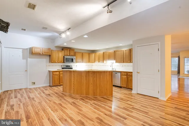a view of a kitchen with wooden floor