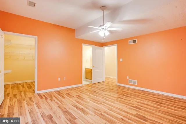 a view of an empty room with stairs and ventilation