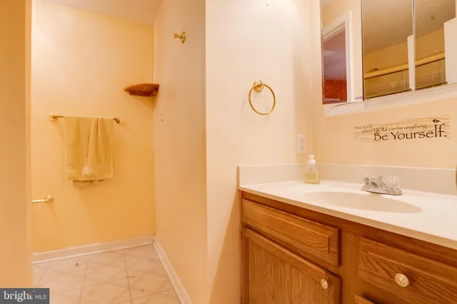an empty room with chandelier fan and windows