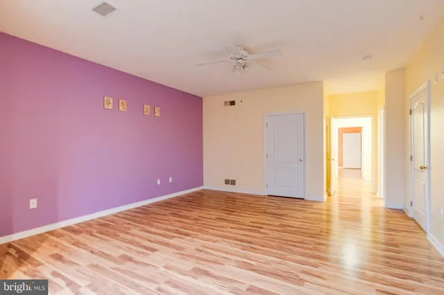 a front view of a house with a yard covered with snow