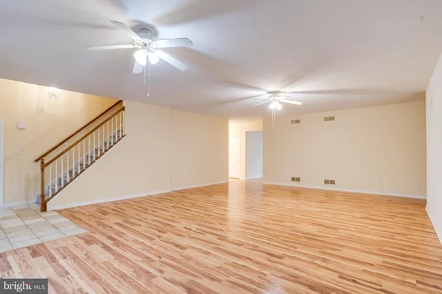 a view of empty room with wooden floor