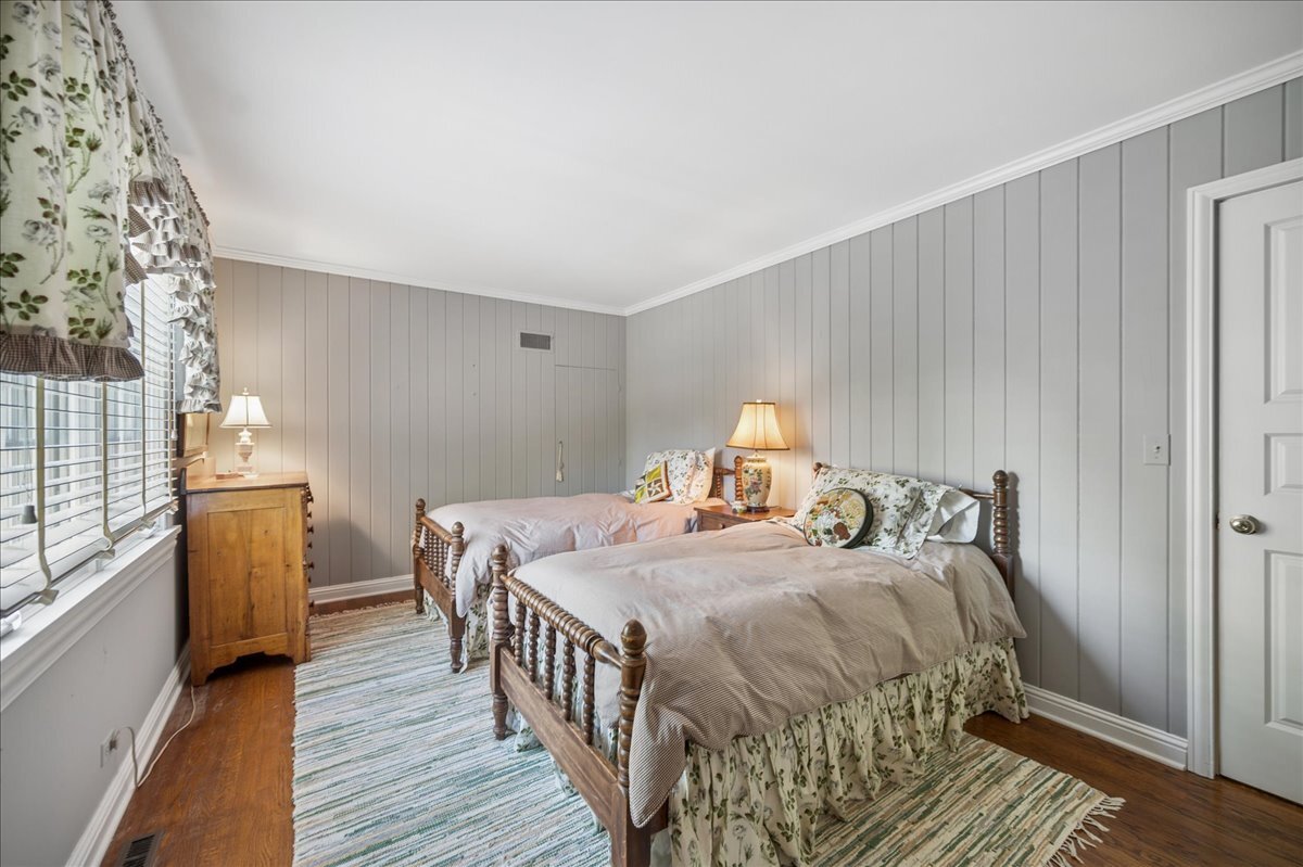 253 Summerfield Road Northbrook, IL 60062 - Photo 29 of 46 a bedroom with a bed and wooden floor