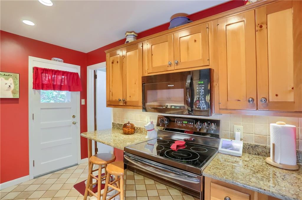19 Marquette Road Pittsburgh, PA 15229 - Photo 19 of 38 a kitchen with stainless steel appliances a stove a sink and a microwave