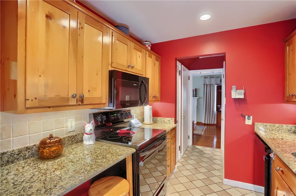 19 Marquette Road Pittsburgh, PA 15229 - Photo 20 of 38 a kitchen with granite countertop wooden cabinets and a stove top oven