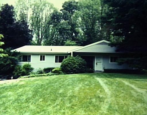 10 Deerfield Road Darien, CT 06820 - Photo 1 of 1 a front view of a house with a yard and trees