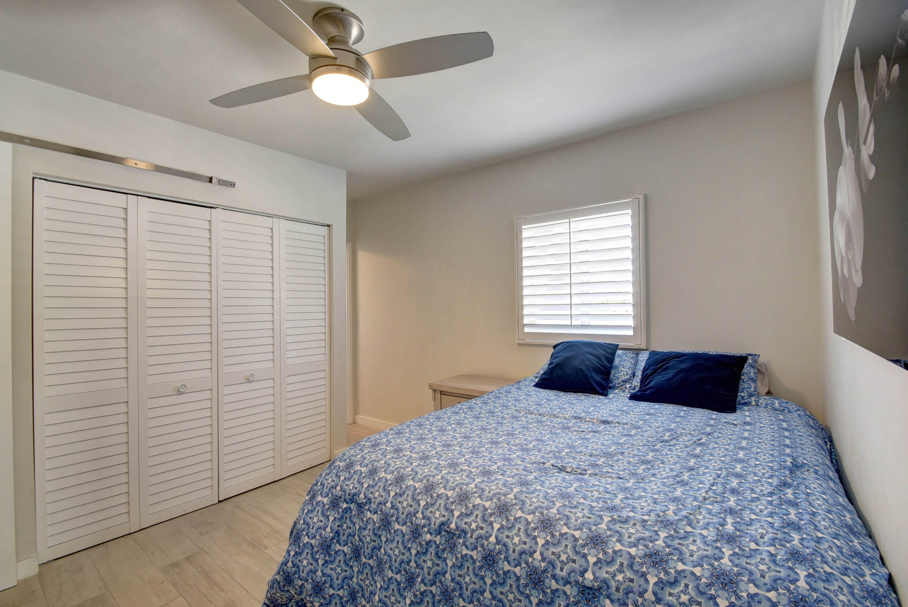 1020 Casuarina Road Delray Beach, FL 33483 - Photo 11 of 17 a bedroom with a large bed and a chandelier