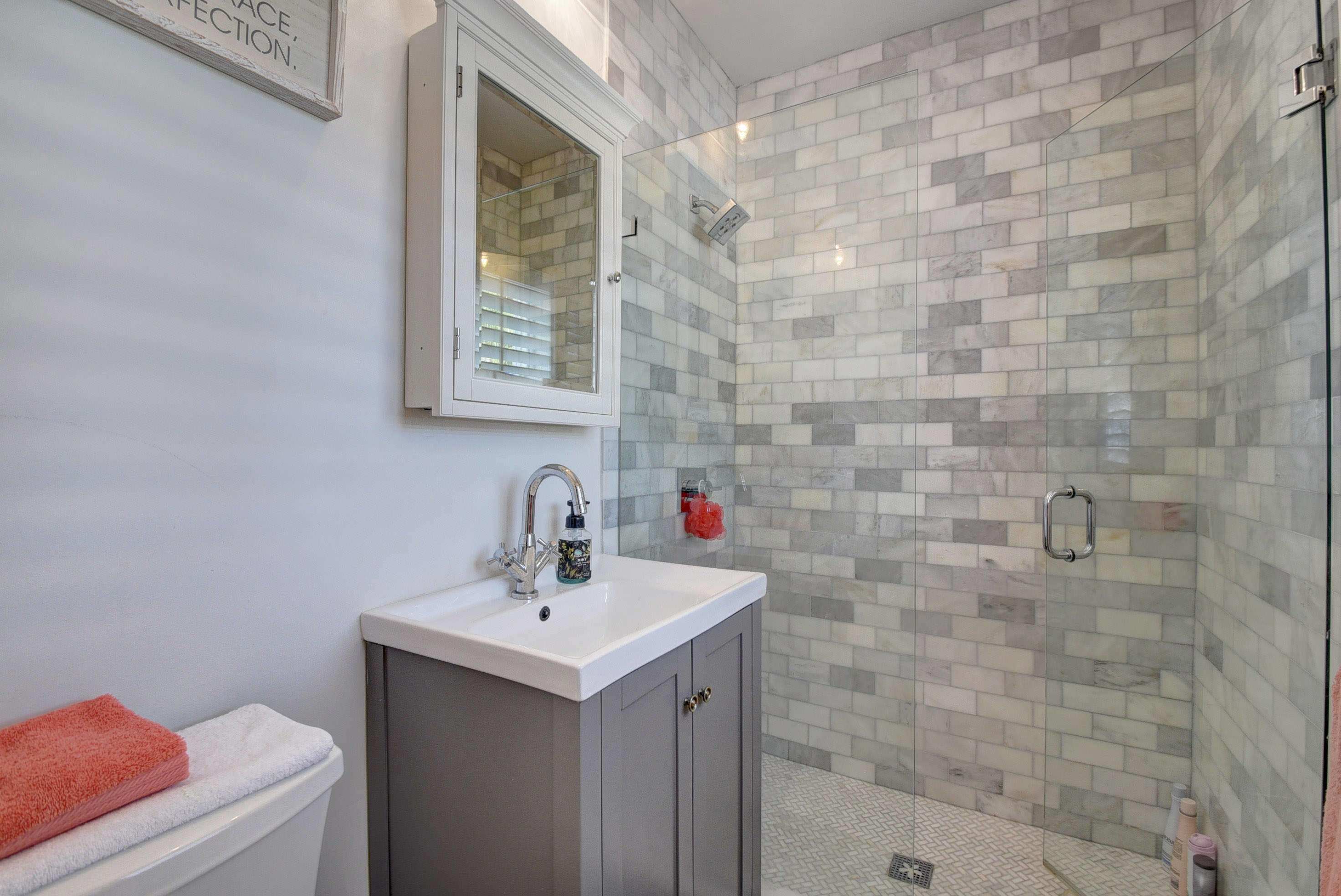 1020 Casuarina Road Delray Beach, FL 33483 - Photo 13 of 17 a bathroom with a sink and a mirror