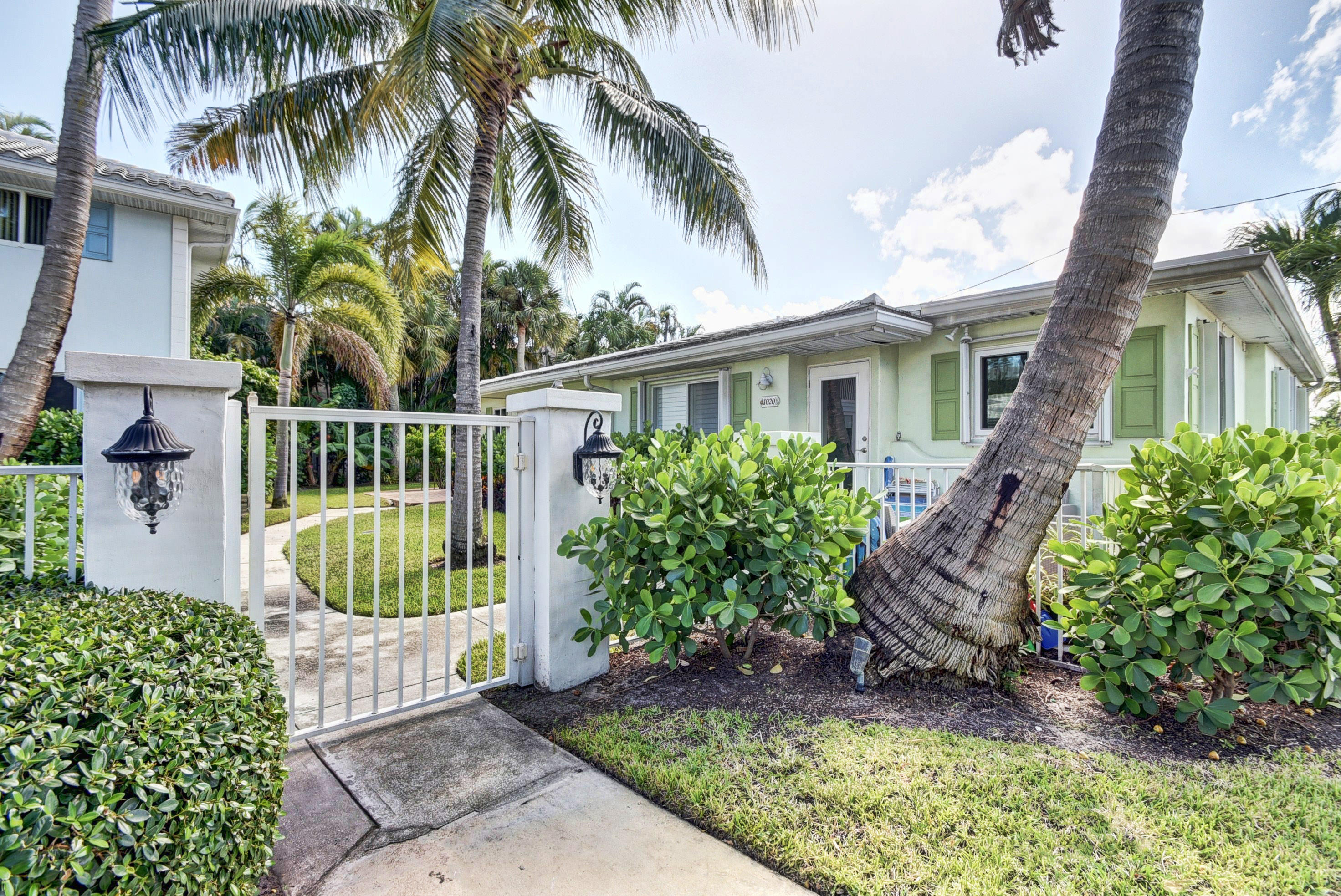 1020 Casuarina Road Delray Beach, FL 33483 - Photo 14 of 17 a front view of a house with a garden