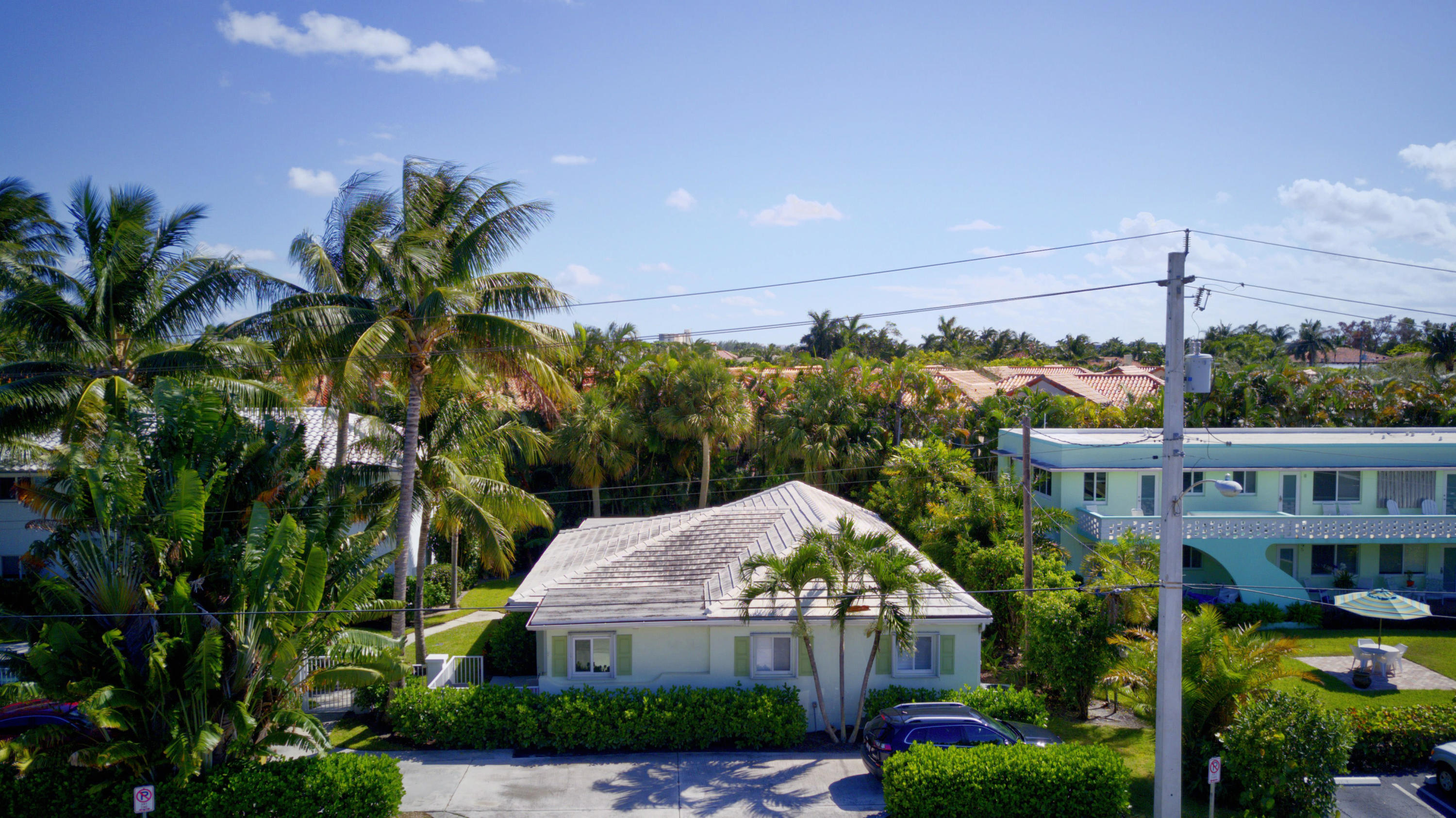 1020 Casuarina Road Delray Beach, FL 33483 - Photo 17 of 17 a front view of a house with a yard and potted plants